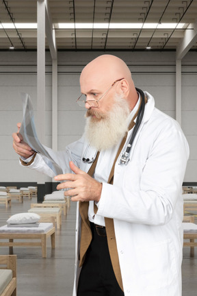 Man in a lab coat looking at x-ray