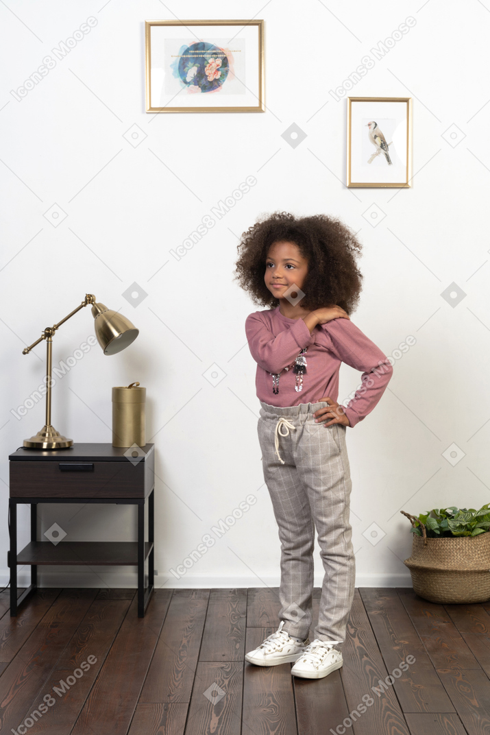 Cute girl kid posing on the apartments background