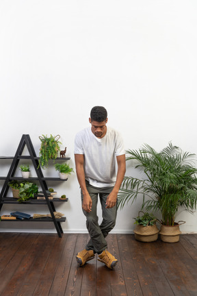 Handsome athletic man posing on the background of the apartment