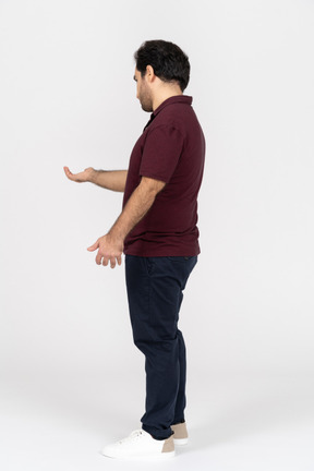 Side view of a man holding out his hand