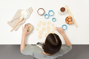 A female baker making cookies