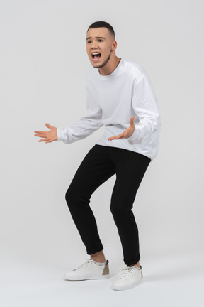 Young man in casual clothes shouting