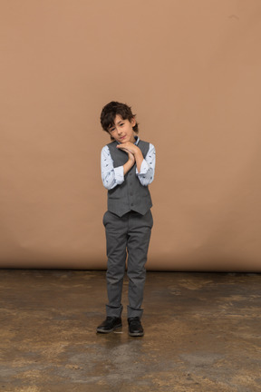 Front view of a cute boy in grey suit