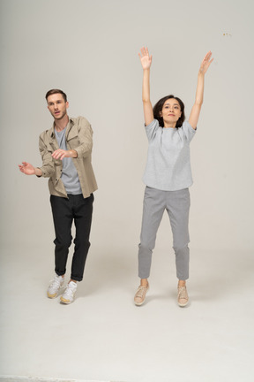 Active young man and woman dancing