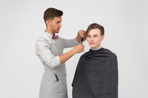 A young barber and his client