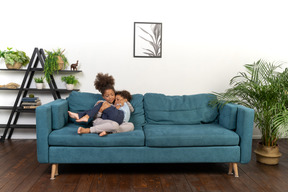 Good looking boy and girl play on the sofa