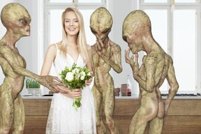 Aliens looking at woman in white dress holding bouquet of flowers