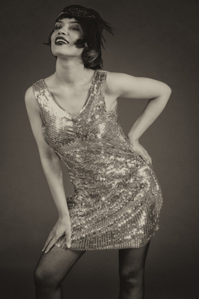 Sensual retro-styled female posing in sequin dress