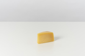 Piece of cheese on grey background