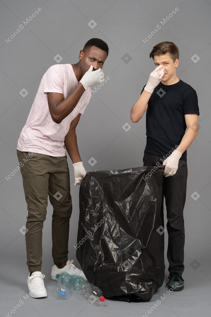 Two men closing noses because of a bad smell