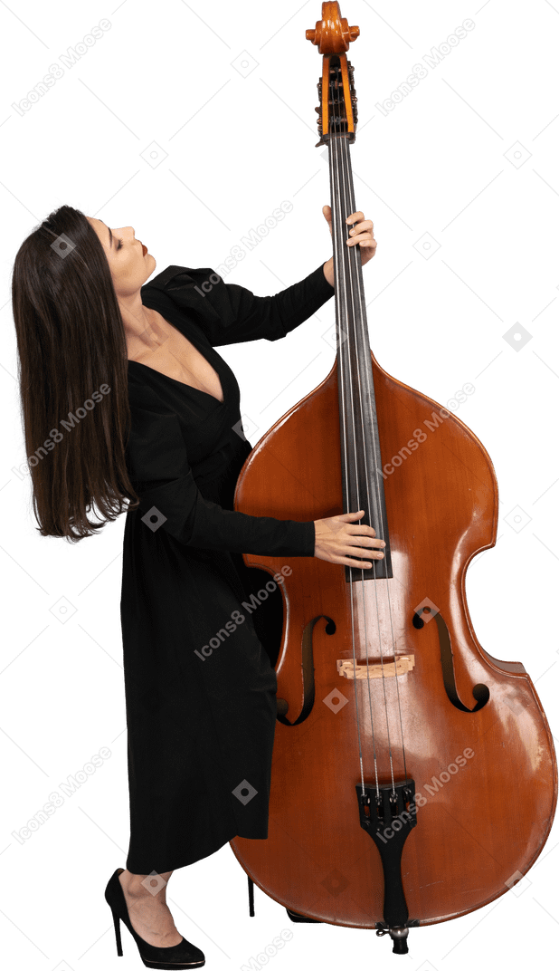 Full-length of a young female in black dress playing the double-bass while leaning back