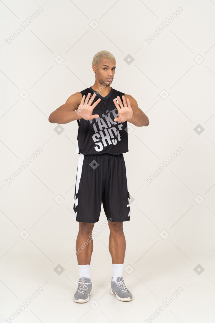 Front view of a refusing young male basketball player outstretching his arms