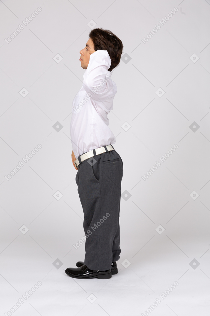 Side view of a male office worker saluting