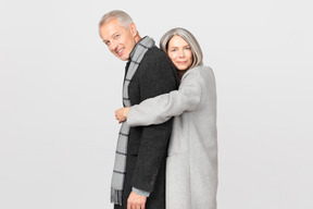 Woman in gray coat hugging her husband