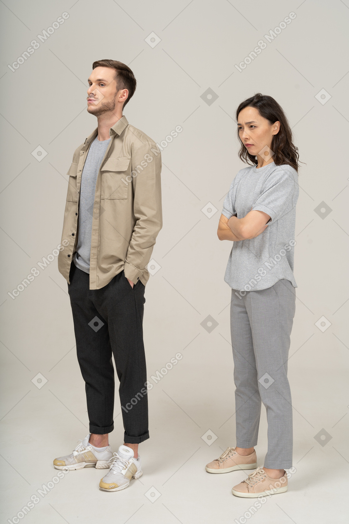 Three-quarter view  of young couple being annoyed