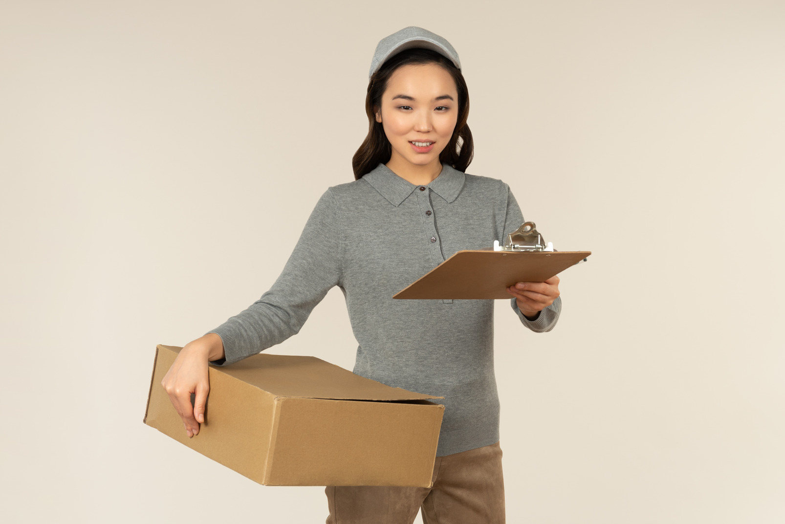 Young asina delivery girl carrying boxes