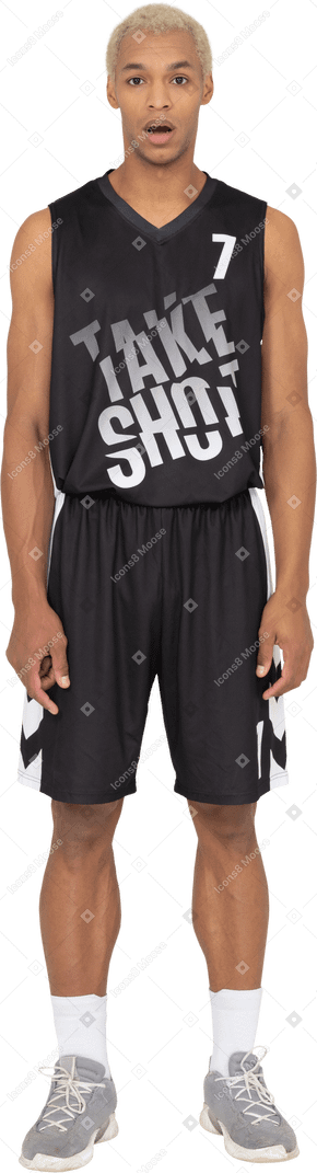 Front view of a shocked young male basketball player standing still