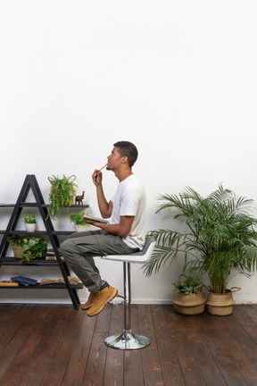 Good looking young man sitting on a chair