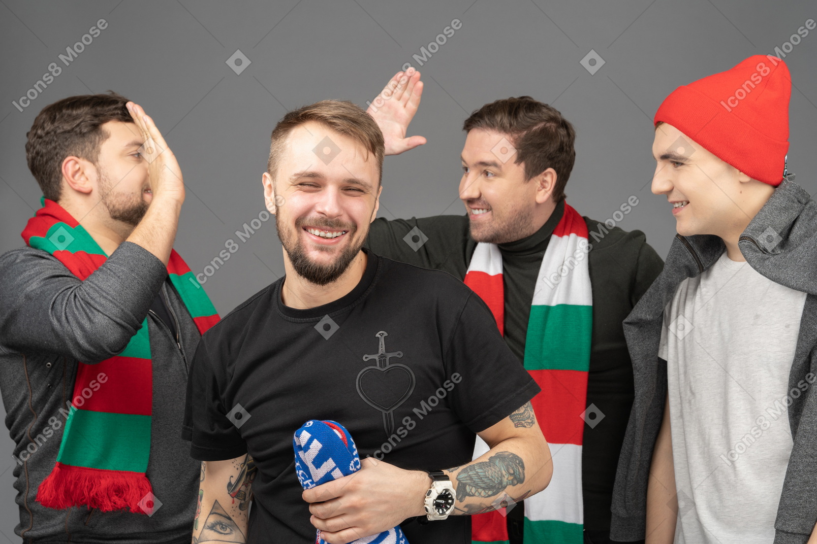 Close-up of four male football fans celebrating the victory