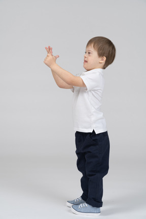 Side view of boy holding his hands together