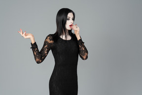 Morticia addams standing in profile and gasping