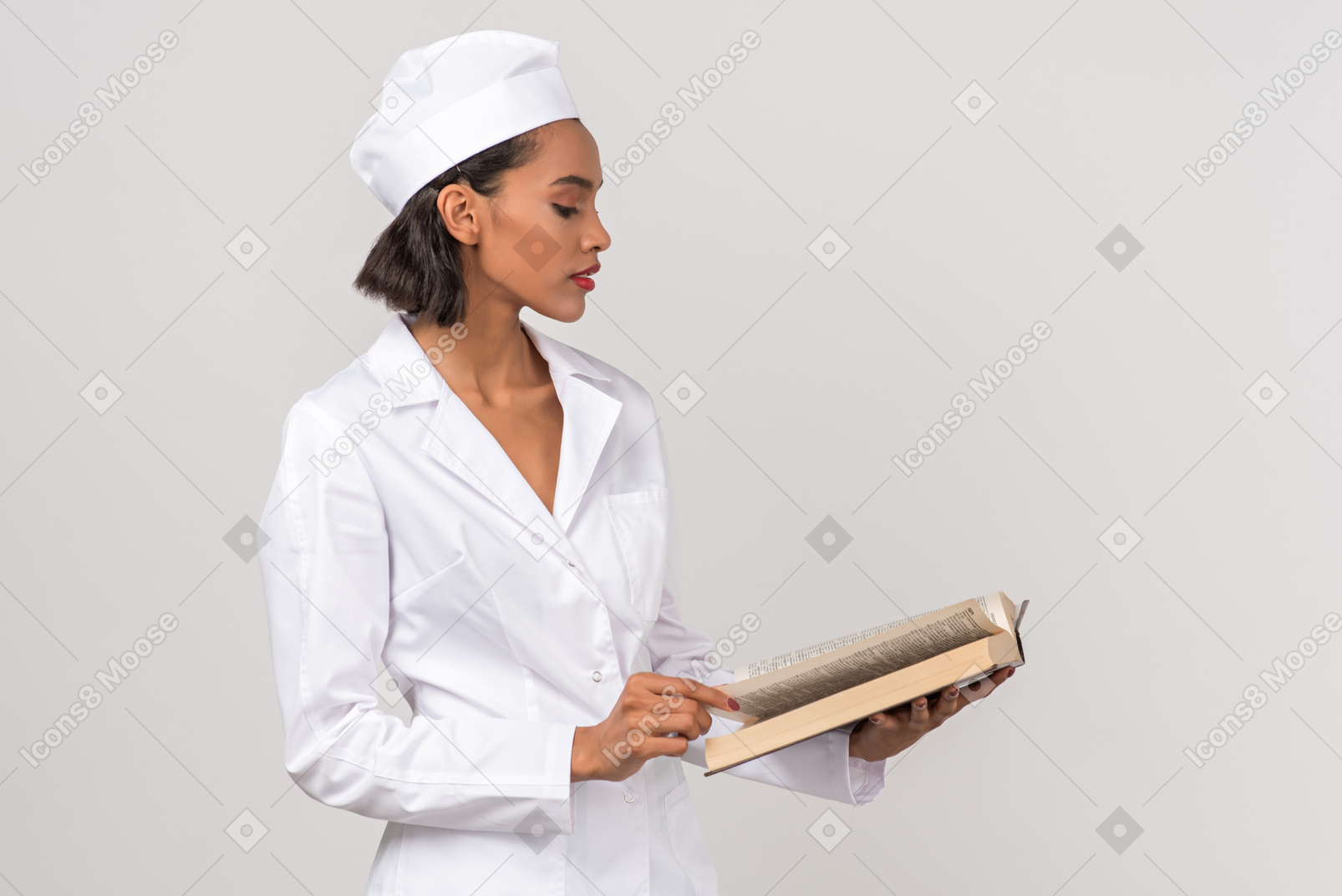 Attractive female doctor looking for something in a book