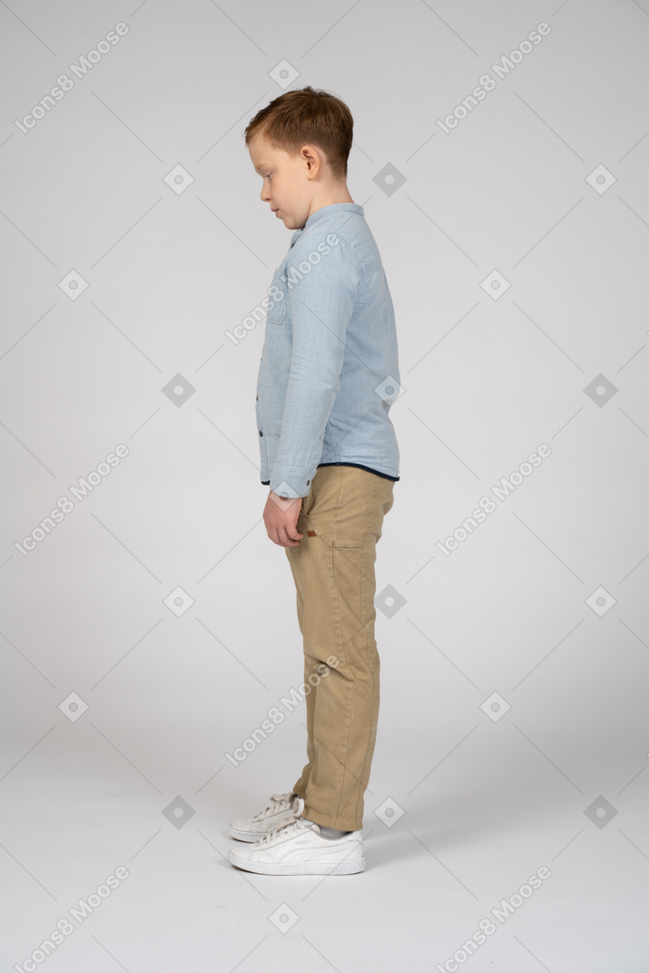 Side view of a boy looking down