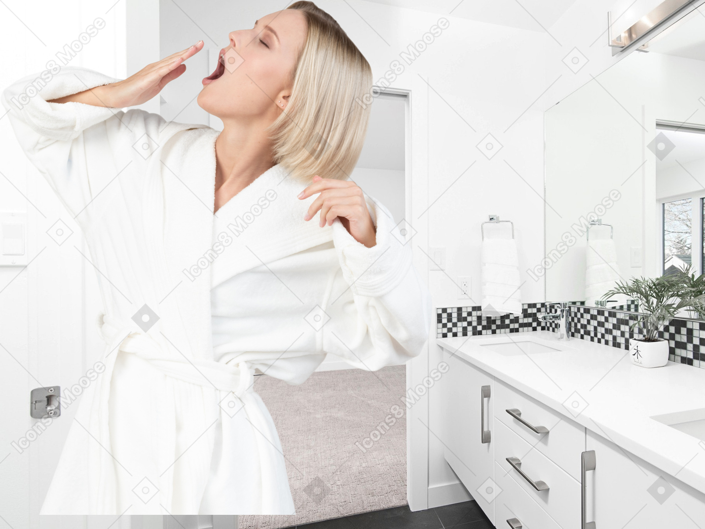 A woman in bathrobe yawning in a bathroom