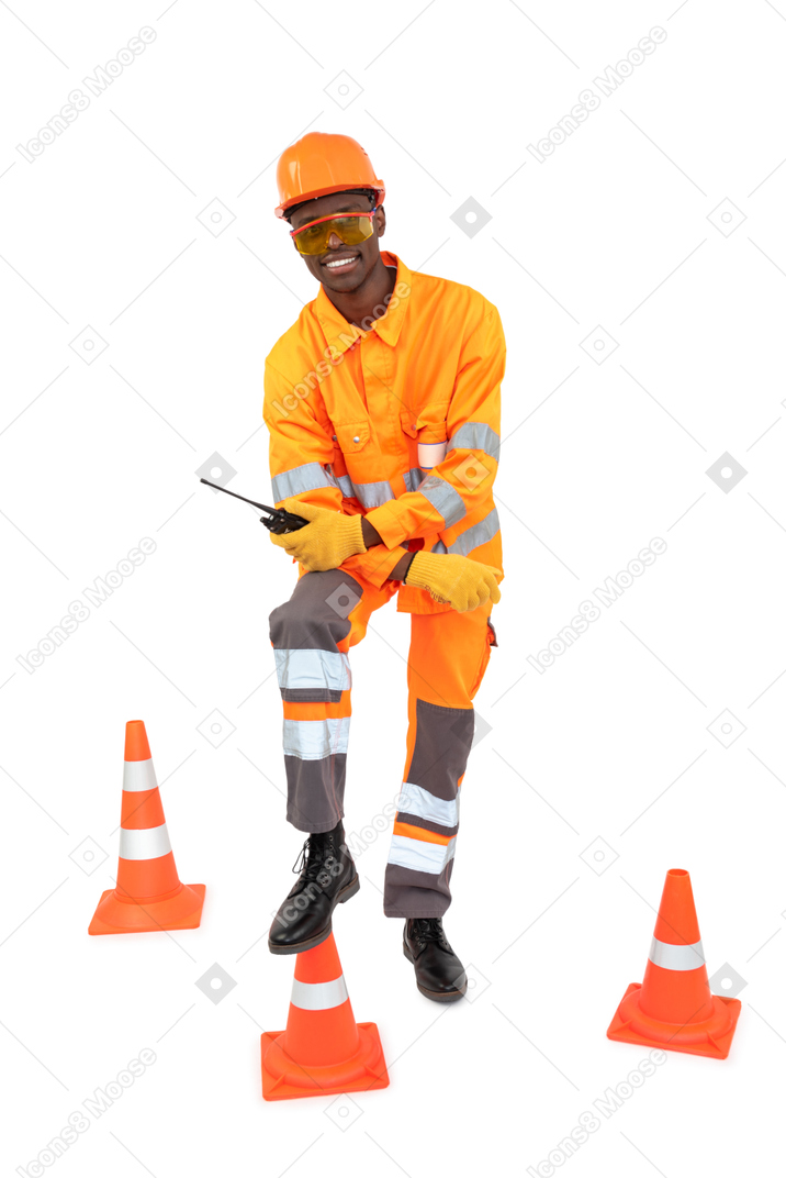 Construction worker holding radio phone and smiling