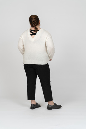 Rear view of a plump woman in casual clothes