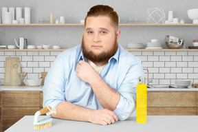 A man sitting at a table with brush and cleaner