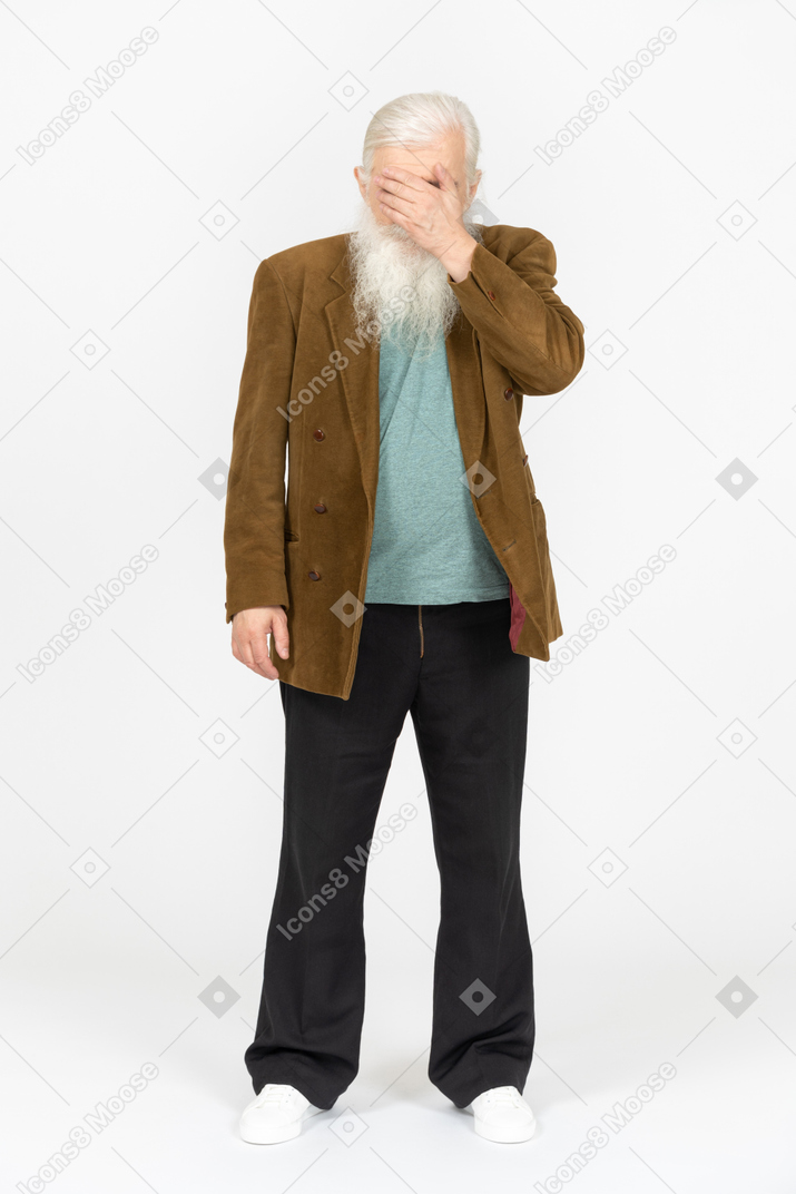 Portrait of an elderly man covering his face