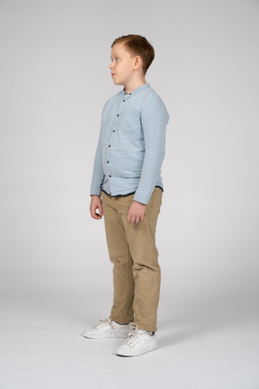 Side view of a boy in casual clothes standing still