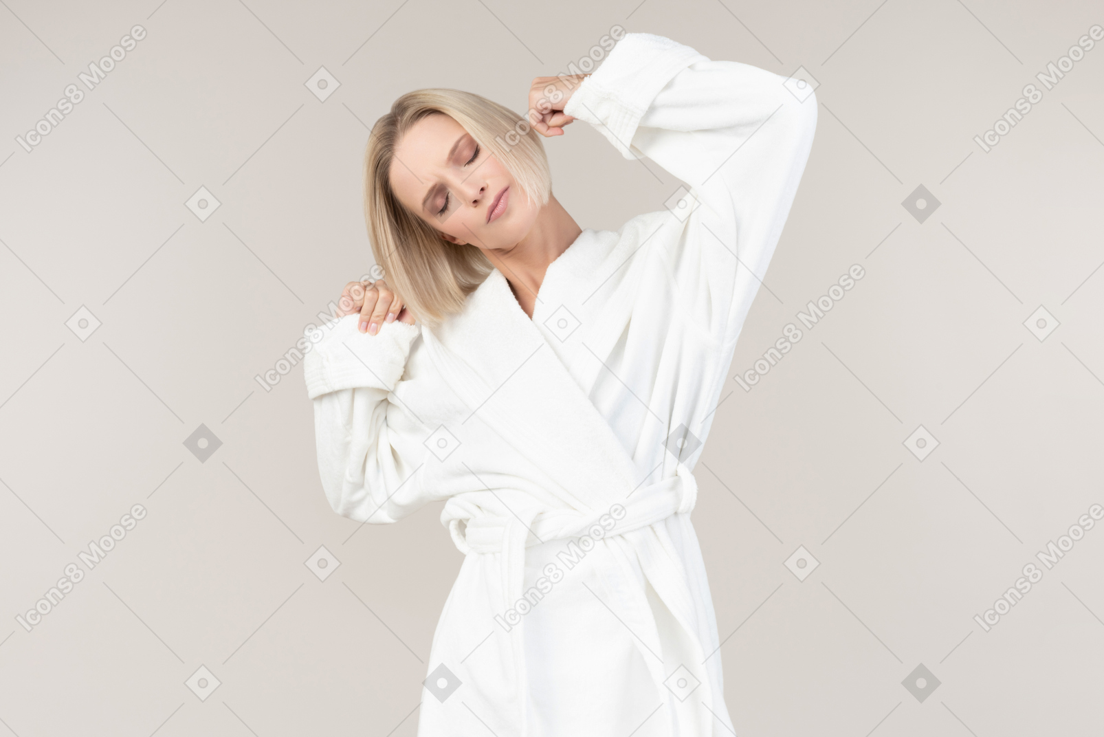 Pretty young girl in bathrobe stretching hands