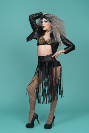 Drag queen in black leather jacket posing with hand on hip