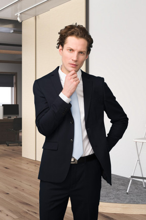 A man in a suit is posing for a picture