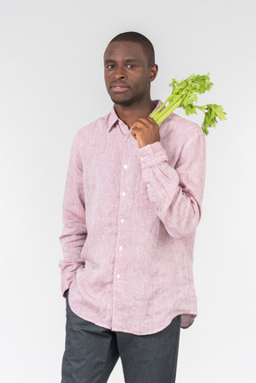 Good looking young man holding flowers