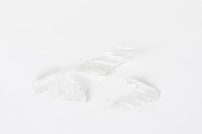 Broken glass pieces on white background