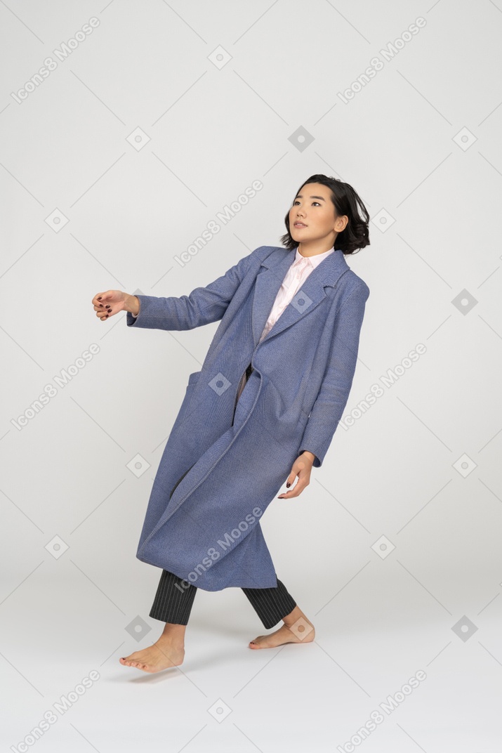 Woman in coat leaning backwards