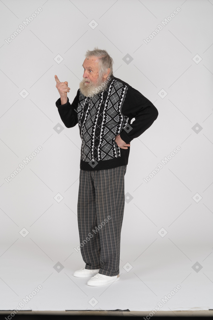 Three-quarter view of an old man pointing his finger