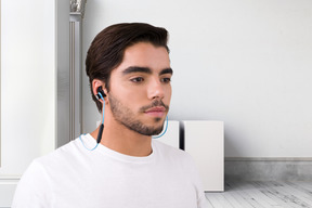 A man wearing earphones in a room