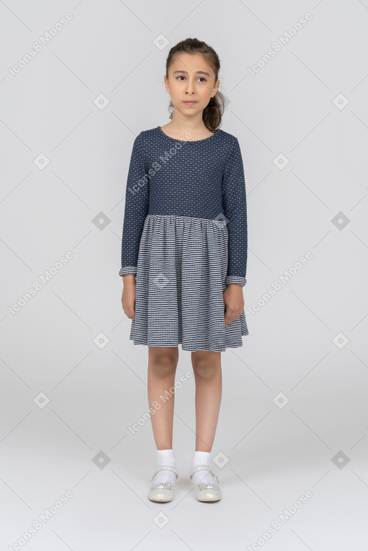 Front view of a girl standing with arms at sides