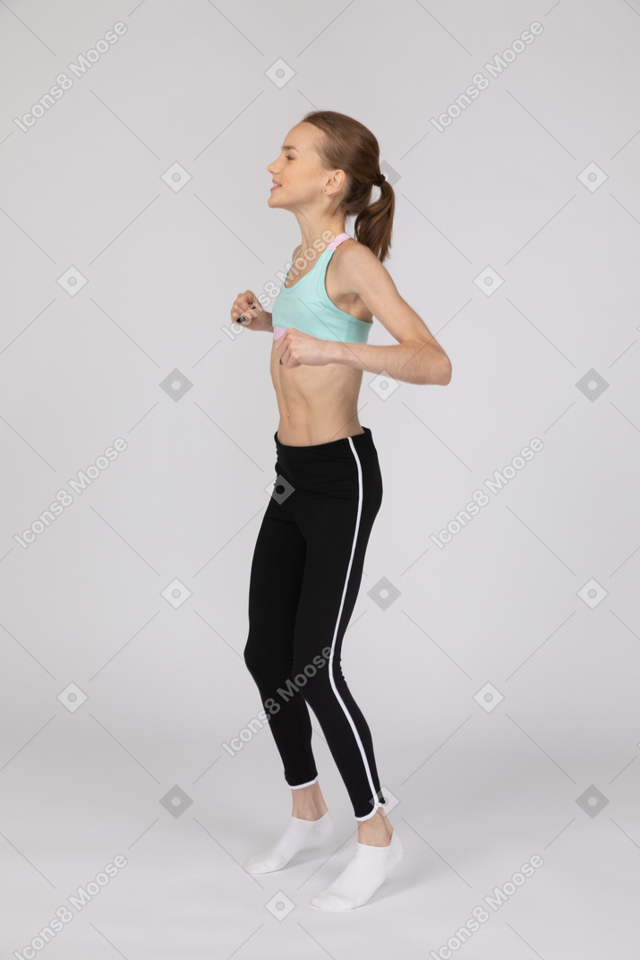 Jumping teenage girl in sportswear