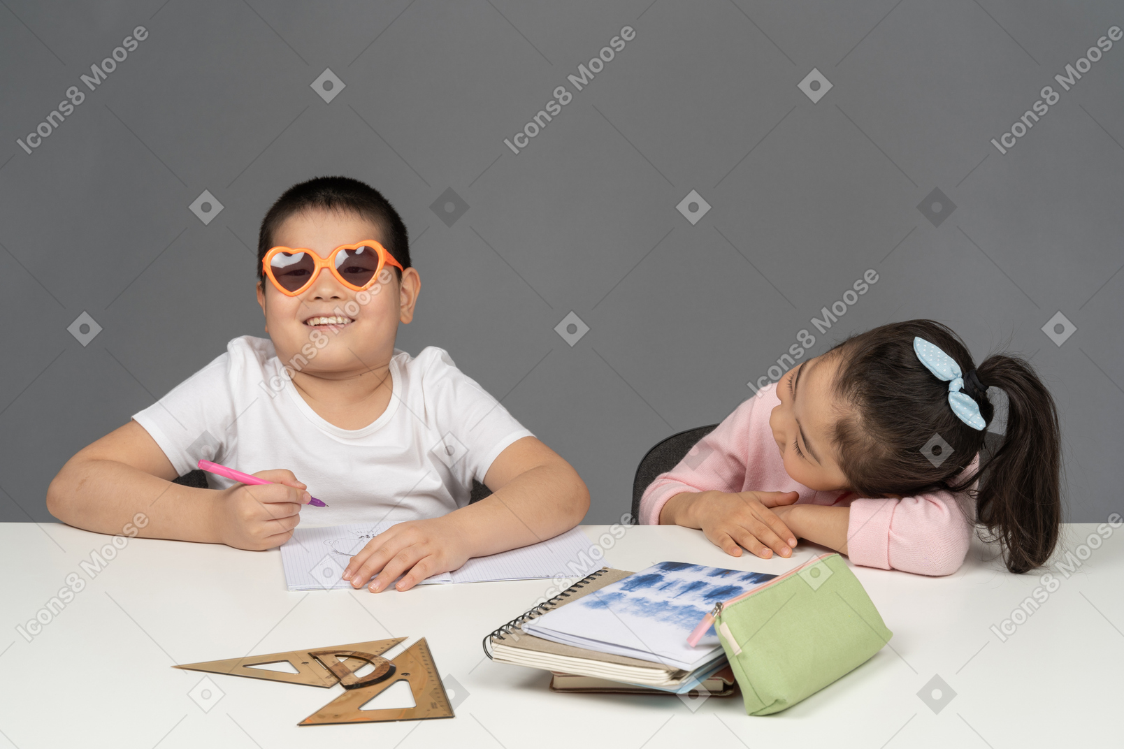 Girl laughing at her brother wearing sunglasses