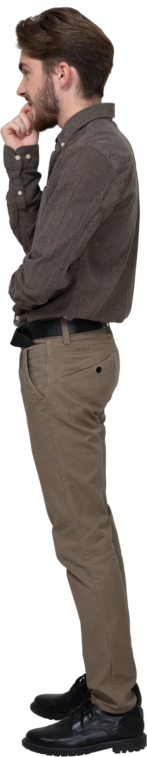 Side view of a nervous young man in office clothing touching chin