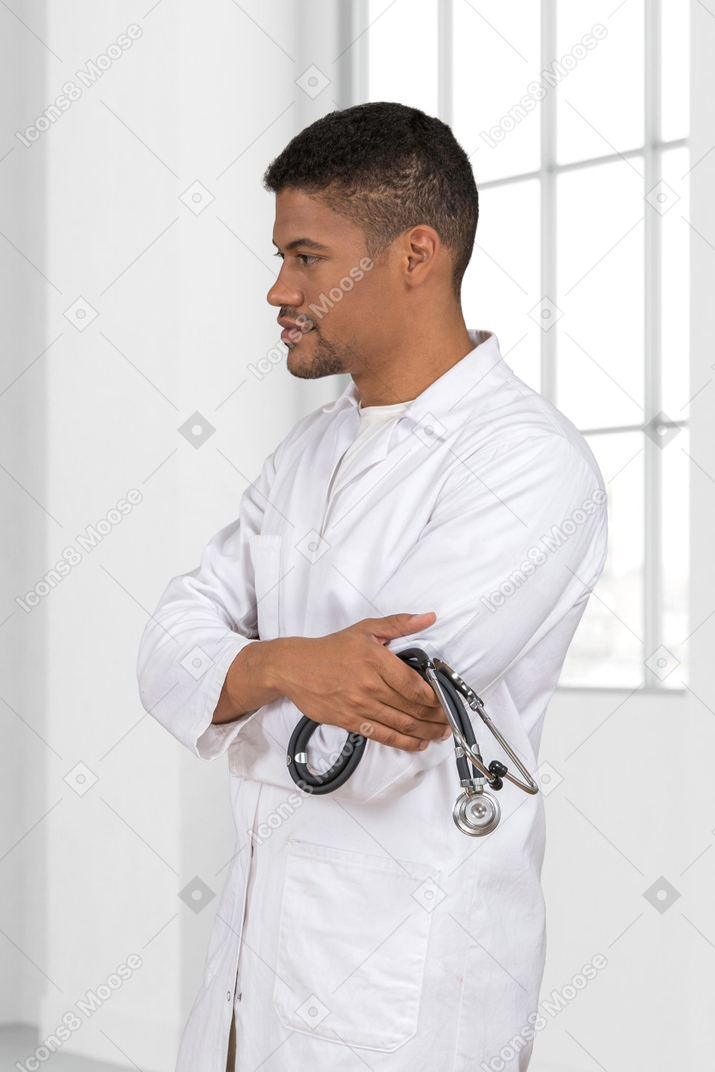A man in a white lab coat with a stethoscope