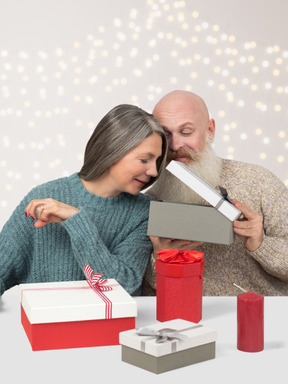 Senior couple exchanging christmas gifts