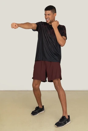Young man in sports clothes exercising