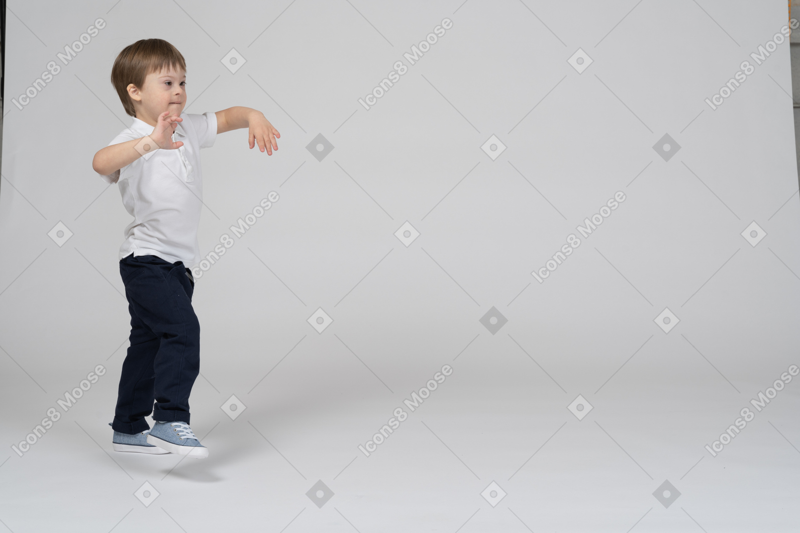 Three-quarter view of a boy jumping and playing around