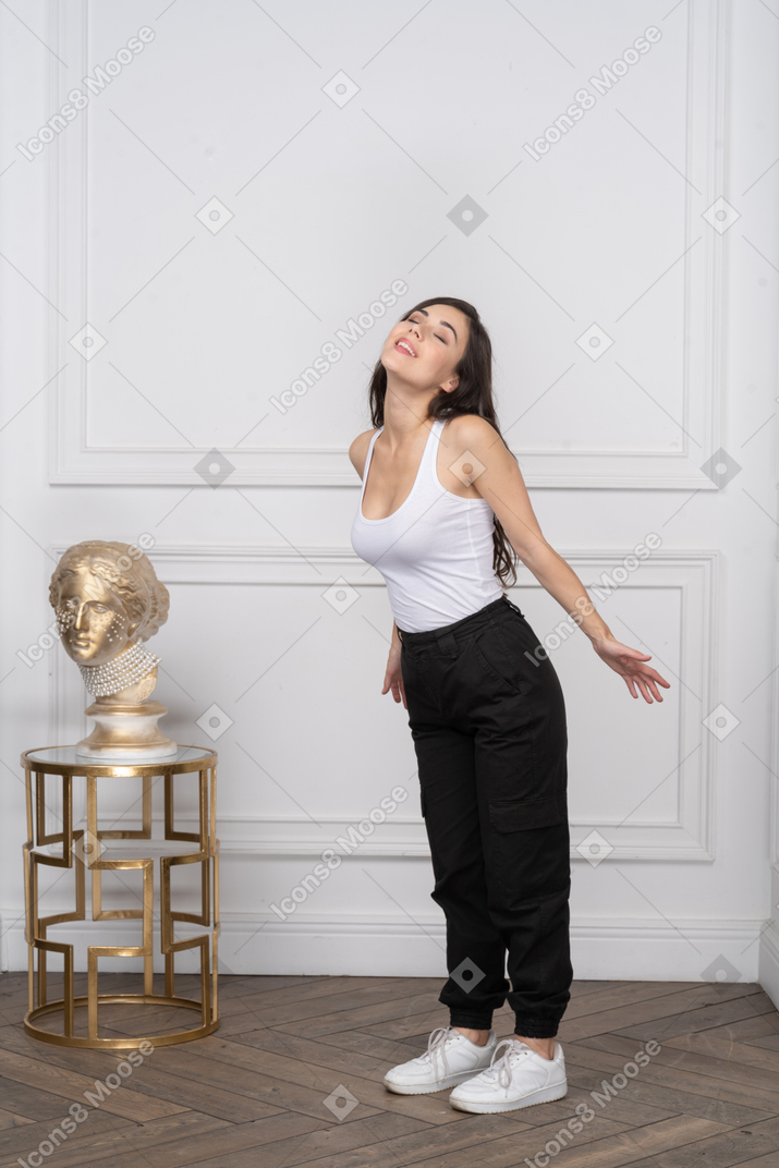 Woman smiling with arms behind back